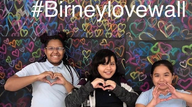 Birney Art Club students in front of the love wall.